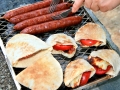 Grilled sausages,halloumi cheese with tomatoes in pita bread.